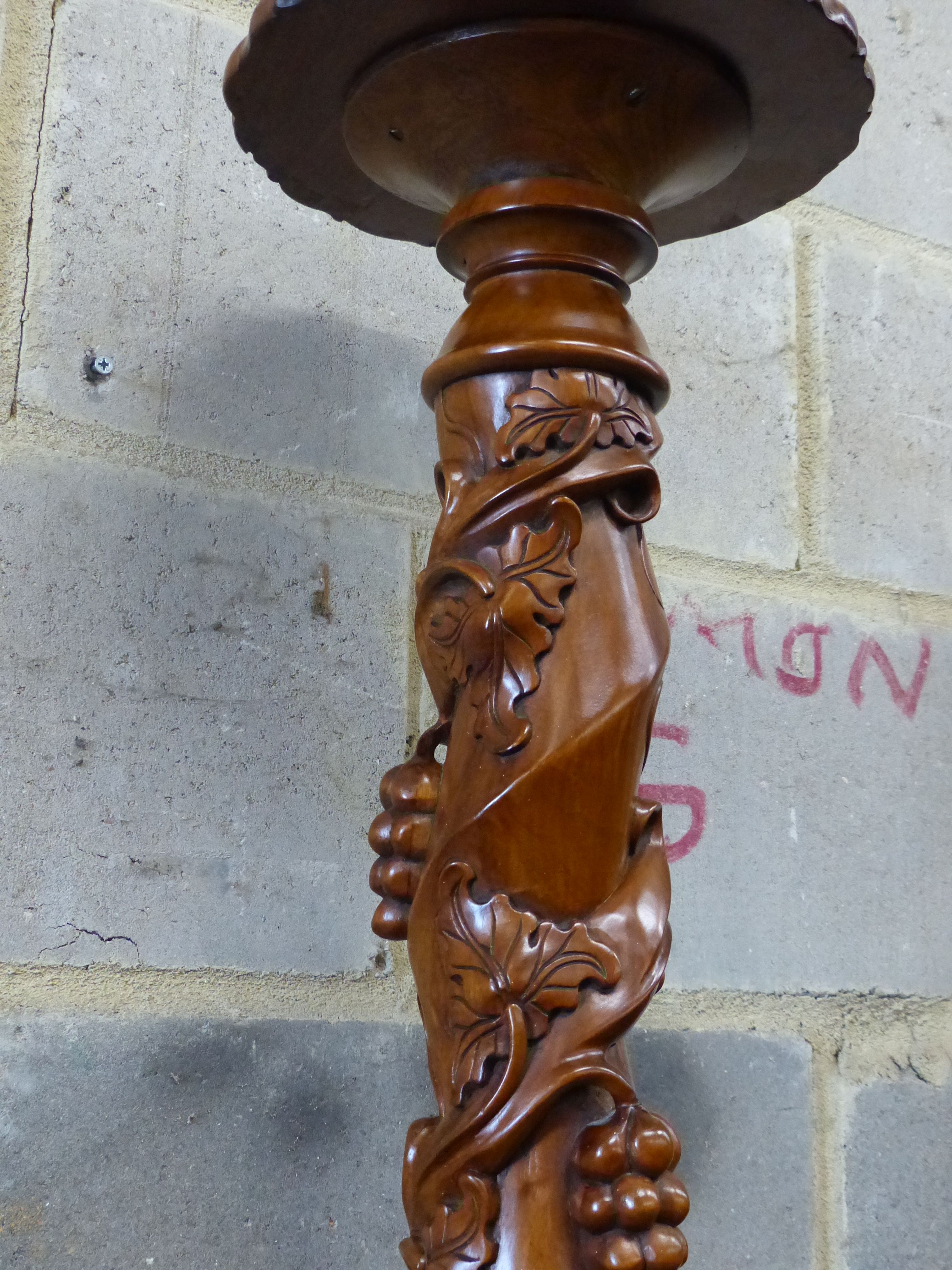 A reproduction carved mahogany torchere, height 114cm
